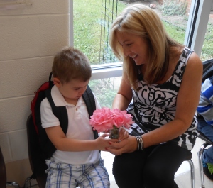 Philip gives his teacher roses from Grandma's house on the first day of school
